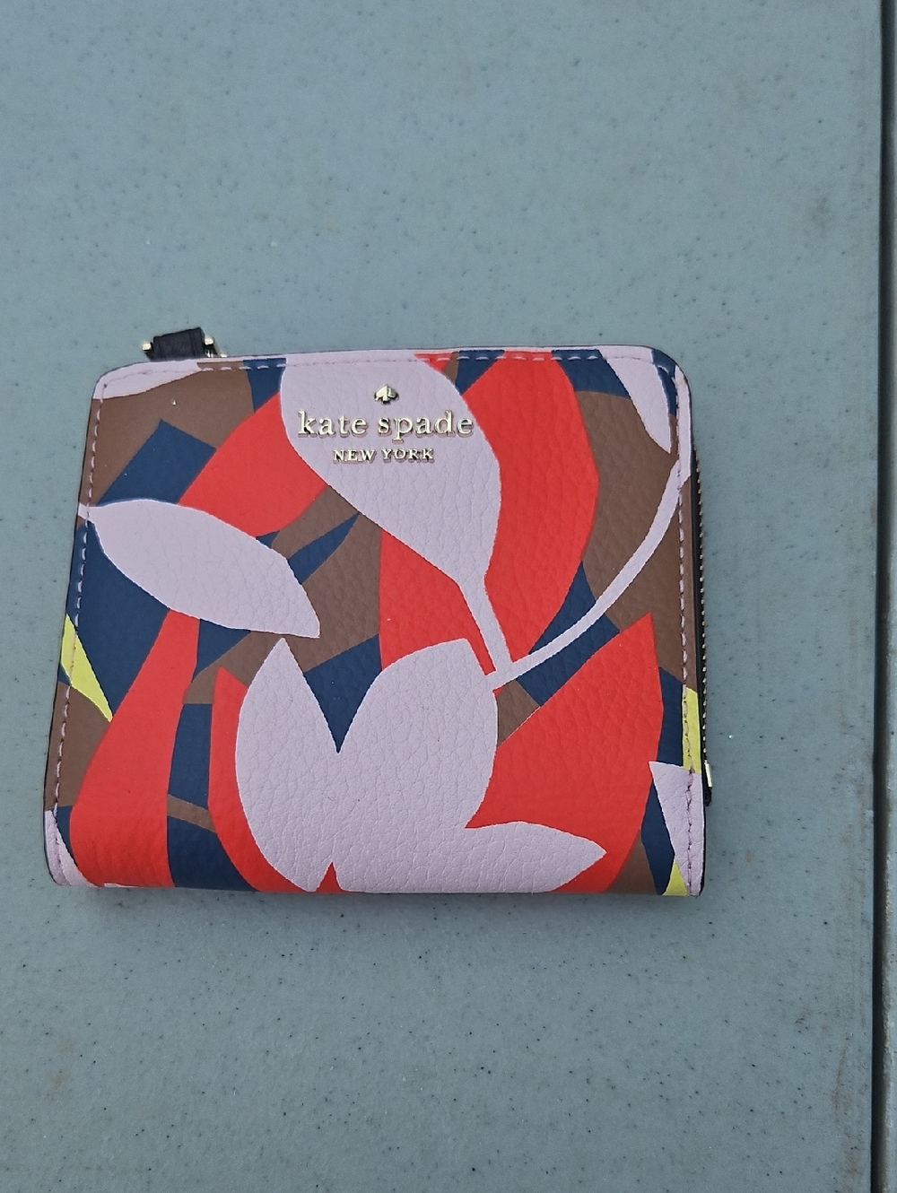kate spade floral zip-around wallet in pink, red, navy, brown and yellow